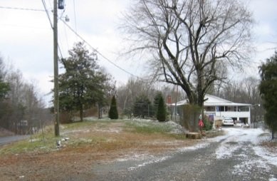 A head-on shot shows the site of the Sodder house, along with a new house built on the land.