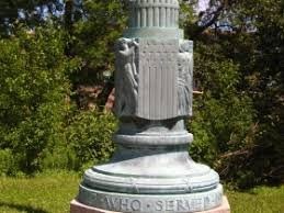 A closer shot of the base of the flagpole showing the "of those that served" and the bas relief above it.