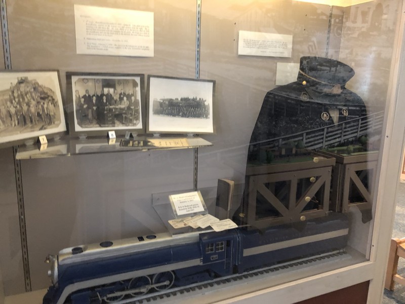 A variety of B&O memorabilia is on display, including photos, a model engine, and a uniform belonging to William Andrew Hiatt, B&O conductor from 1917 to 1942.