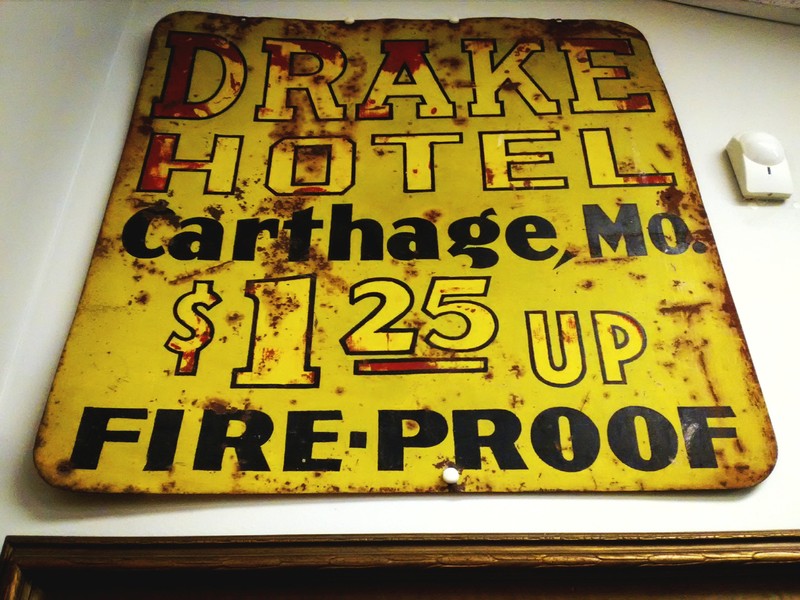 Early metal sign from Drake Hotel on display at the Powers Museum.
