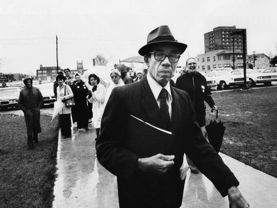 1975 - Lyman Johnson walking past busing opponents.  Courier- Journal