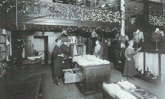 Interior of building when Burkett-Andrews Dry Goods occupied this address in 1921. Store is decorated for Christmas. (1)