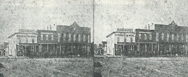 McCrillis Brothers early hardware, stoves and tinware store at corner of 4th and Grant streets, circa 1878-79. Burlingame and Chaffee Opera House (now 136 E. 4th) can also be seen in this stereo view image. (1)