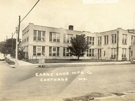 Partial view of the Carmo Shoe Manufacturing Company located at the corner of Garrison Avenue and Oak Street (also known as U.S. 66 and U.S. 71 at the time of this image, circa 1930s).