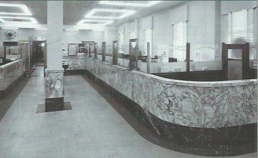 Interior of Bank of Carthage Building, circa late 1940s. H. E. Williams light fixtures are visible in the ceiling. The marble wainscotting around the center column can be seen today inside the Carthage Deli.