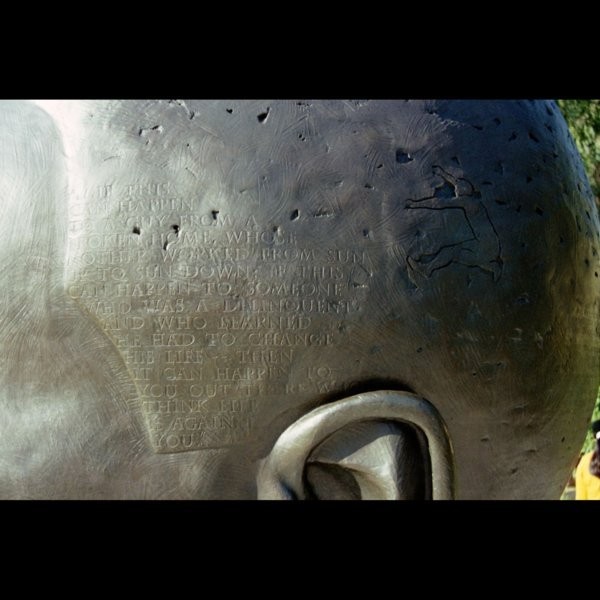 Detail of sculpture's hair, listing the Robinsons' accomplishments. (Sandcart Studios/Stuart Schechter).