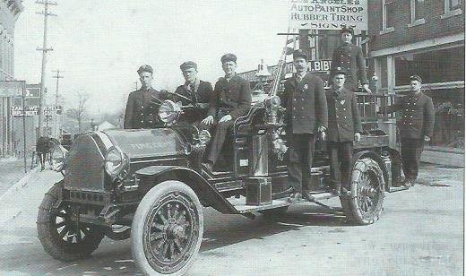 Carthage firemen outside City Hall building on Grant Street circa 1914-15. Pictured are Carthage's second Fire Chief S S Mathews (third from left) and firemen (left to right) Neely, Whiteman, Wheeler, Huffer, Ayler, and Woods (no first names).