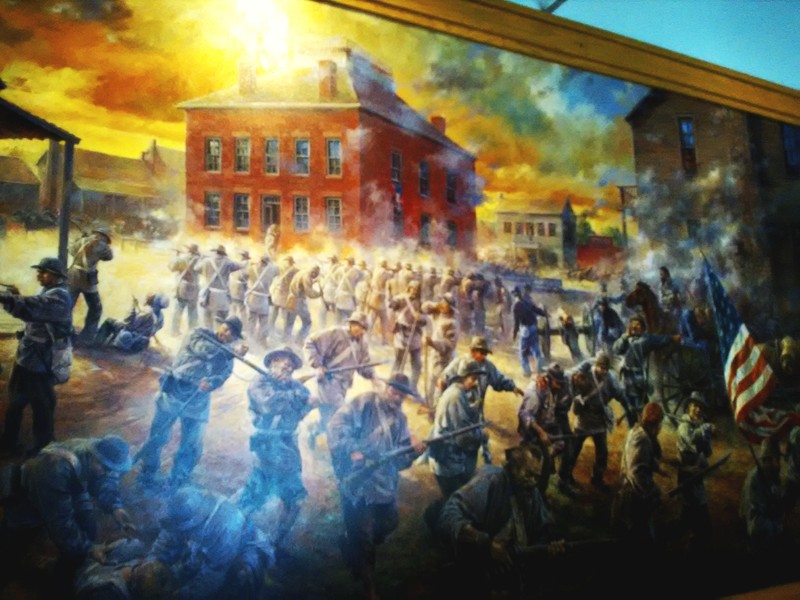 Part of larger mural on the Battle of Carthage that greets visitors entering the Civil War Museum. The work was created by Carthage artist Andy Thomas and features battle action around the former Jasper County Courthouse.