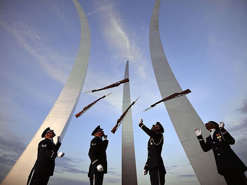 U.S. Air Force Honor Guard members performing in front of the memorial