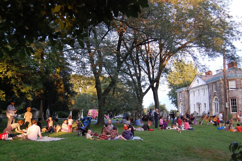 Visitors gather on the back lawn of the Woodlands mansion.