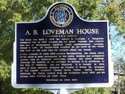 This historical marker stands on the sidewalk in front of the house.