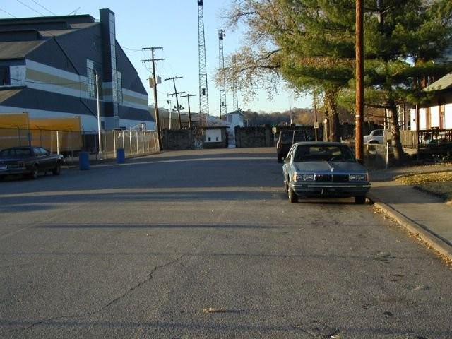 View down F Street of the stone wall and ticket booth at Oakes Field. The Charleston Ordnance Center at left, built weapons for the U.S. Navy while the field was under construction, as the U.S. entered WW2 in December 1941. Photo by Bob Lilley.