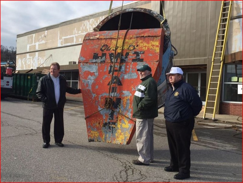 The paint can descends during the 2015 removal ceremony. At left is South Charleston Mayor Frank Mullens. To the paint can's right is Don Evans, last owner of Evans Lumber.