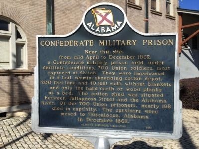 The historical marker describing the prison is located outside a historic 1888 railroad building, which is now part of the Montgomery Biscuits Baseball stadium.