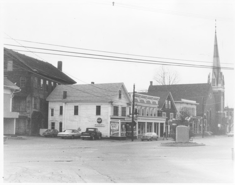 South Side of Main Street incl. Coop Gristmill, Copp Mill 3, Meserve's Store, Copp Block, Page Blick, Bryant and Lawrence, Inc., and the Trinity Church by Roger P. Akeley on December 15, 1982