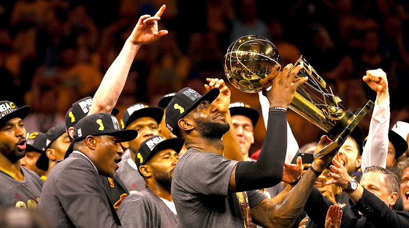 Lebron holding the trophy after coming back 3-1. 