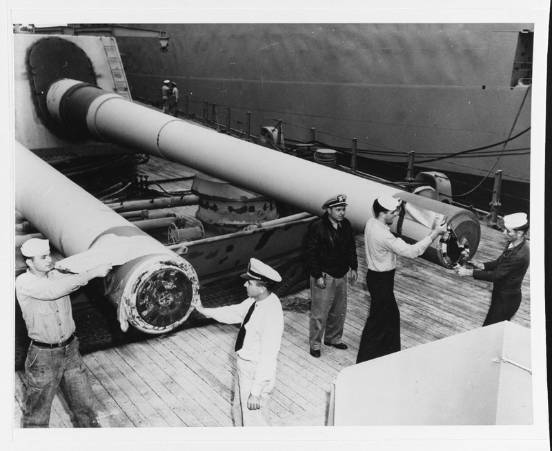 New Jersey's crew remove muzzle seals from the forward 16" guns during her 1950 reactivation. (NHHC)