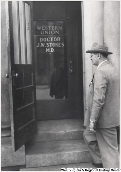 Dr. J.W. Stokes entering his office space in the former Citizen's Bank location. Circa 1930. Source: WVU Local and Regional History Archives.