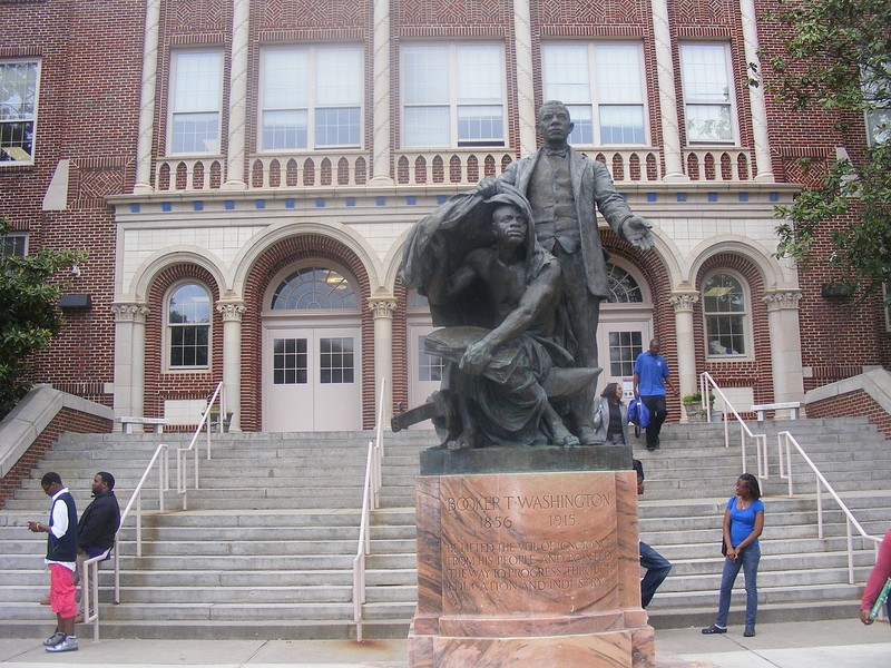 The statue of Washington stands in front of the high school's main entrance.