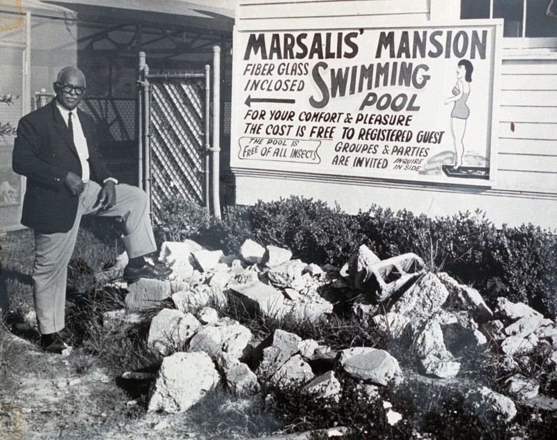 Ellis Marsallis Sr strikes a pose in front of the motel's pool sign.