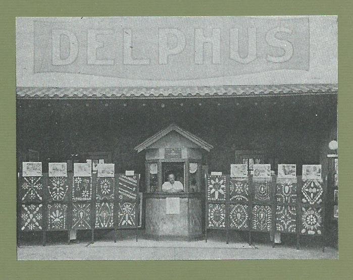 Delphus Theatre entrance on first floor of Cassaday Building. Ulrick Williams is at ticket booth along with George Williams' arrowhead collection. Both were sons of I.P. Williams, theater owner. Former exhibit Powers Museum exhibit mount is undated.