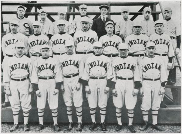 The 1920 Indiana Baseball Team standing on bleachers which were nonexistent in Indiana Baseball's early days. The uniforms have a much more modern look than past designs.