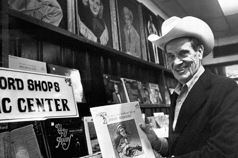 Ernest Tubb Holding a Jimmie Rodgers Album in the Ernest Tubb Record Shop, January 9, 1978 