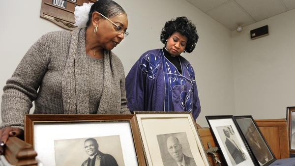 The upper sanctuary on the third floor of Asbury United Methodist Church features artifacts and documents. In this photo, church historian Gloria Brown (left) and Dr. Carletta Allen, pastor, look at portraits of former pastors.