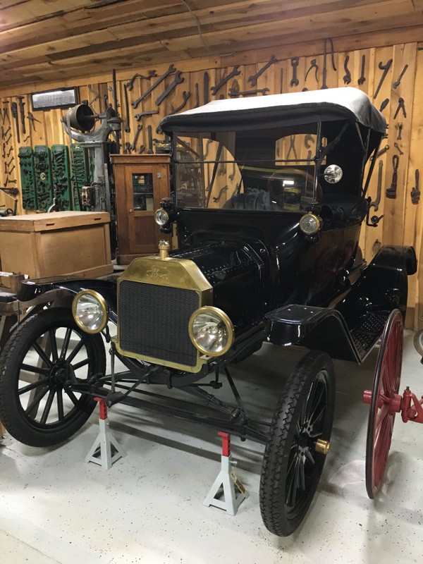 This Ford Model T is a 1915 Runabout version, also known as a Roadster. It had a four cylinder engine, retractable roof, and cost $440. It was the last Ford model to have a brass radiator.