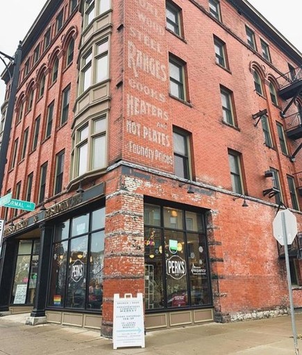 Brick engravings note the Zink Block's mid-twentieth century function as a dry goods and retail center