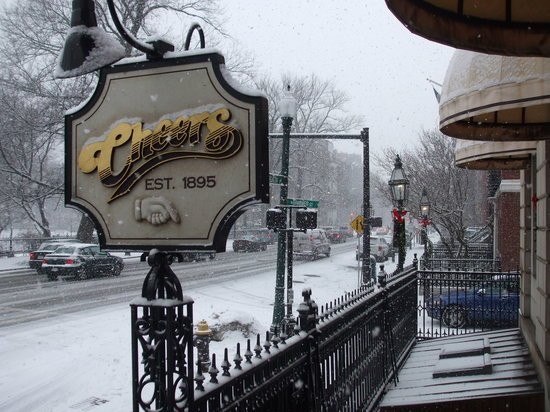 The iconic Cheers signage on a snowy day. The bar was originally known as the Bull and Finch Pub.