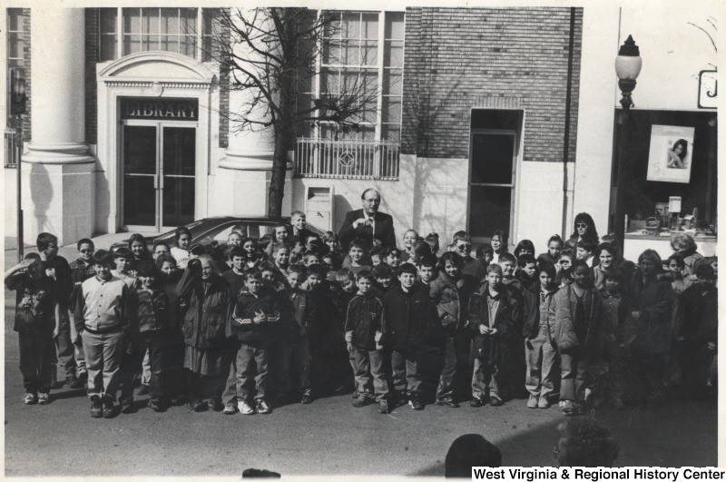 Senator Jay Rockefeller with school children outside the library. ca. 1985, from WV History On View Collection.