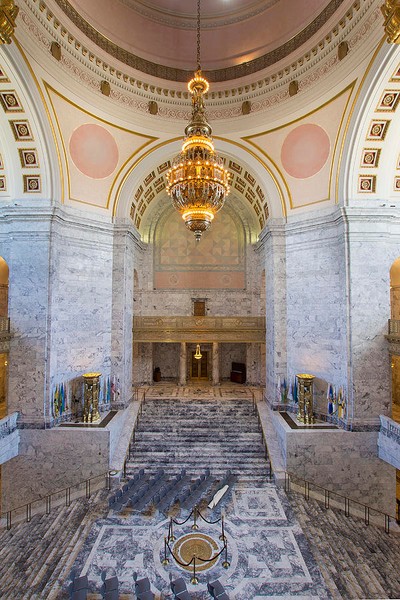 The 10,000 pound Tiffany chandelier hangs above the Washington state seal