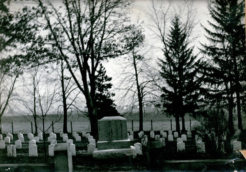 Cabinet card photograph, taken 1896, of the Confederate Rest in Madison, Wisconsin. The photograph features the section of graves at Forest Hill Cemetery in Madison, Wisconsin, reserved for the 136 Confederate soldiers who are buried there, and Alice Whiting Waterman. 