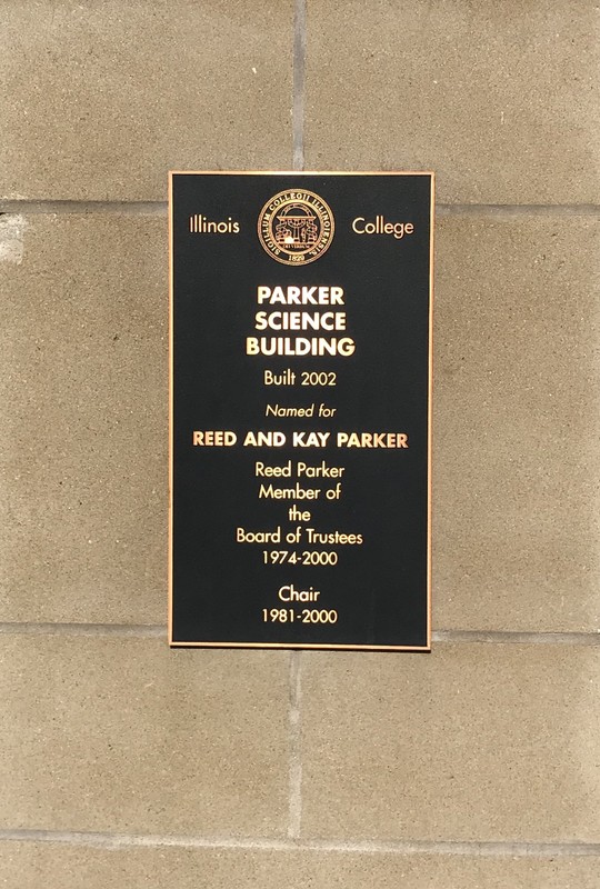 This plaque is on the front of the building that showcases who the building was dedicated to and what he did for the campus. 