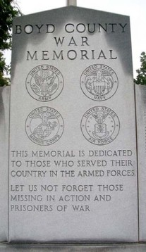 The front and center slab featuring the symbols of the Army, Navy, Marines, and Air Force.