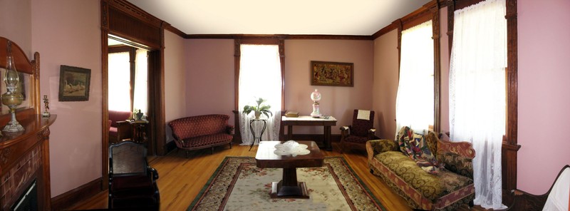 This is the living room and the parlor can be seen with the double pocket door off to the left. 