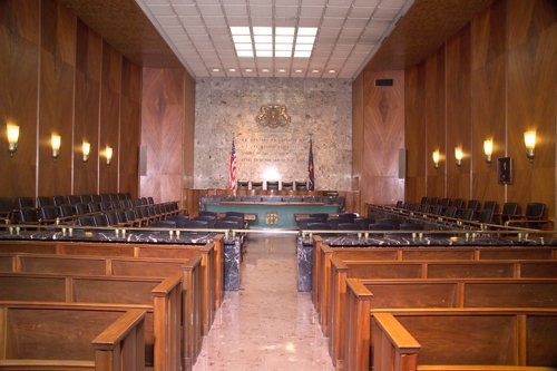 Courtroom #3, or the William Penn Room with white oak paneling and marble wall that holds the Pennsylvania Coat of Arms.  