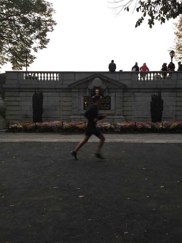 The monument compared to the scale of a human runner in the park. 