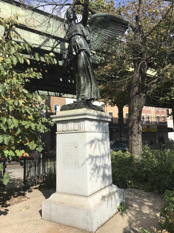 The Statue and lists of names near below the train track.