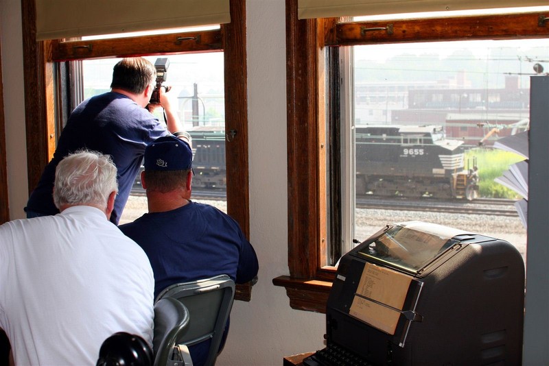 A few railroad aficionados train spotting from the second floor of the Harris Switch Tower.  