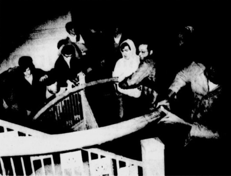 Students line a staircase in the Union while assisting fire crews