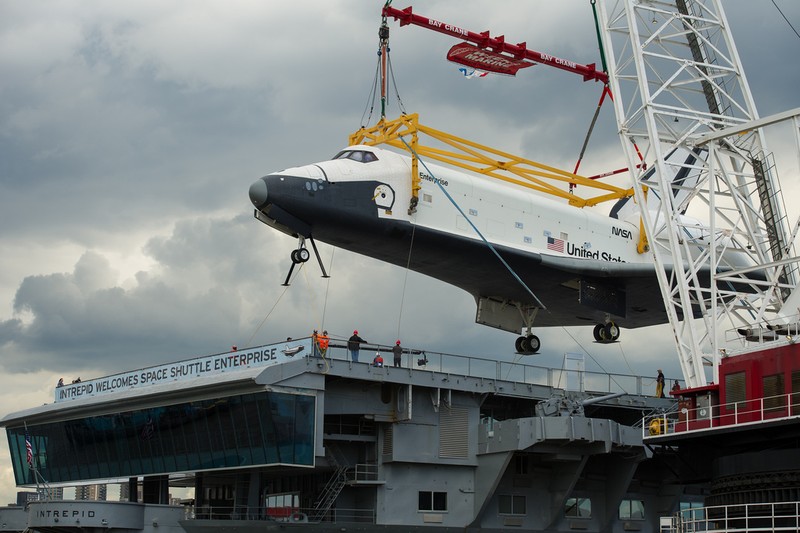 The Enterprise being lowered onto its deck.