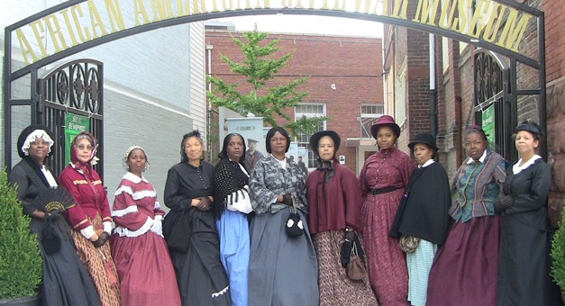 Reenactors dressed in reproductions of period clothing 