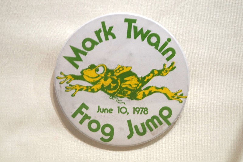 The first press reference to a jumping frog contest in Hartford - commemorating "The Celebrate Jumping Frog of Calaveras County," Clemens's breakthrough work of 1865 - is from 1944 when a tourney was held in Colt Park.  Ten teams represented city boys' clubs and the Hartford Junior Police Legion of Honor.  In the 1950s the Mark Twain Memorial Commission and the Hartford Children's Museum organized an annual contest which was wildly popular.  The winner of the last run race probably wore a button like the one displayed.  In 1979 sentiment against the use of animals in sport led to the discontinuation of the event. 
