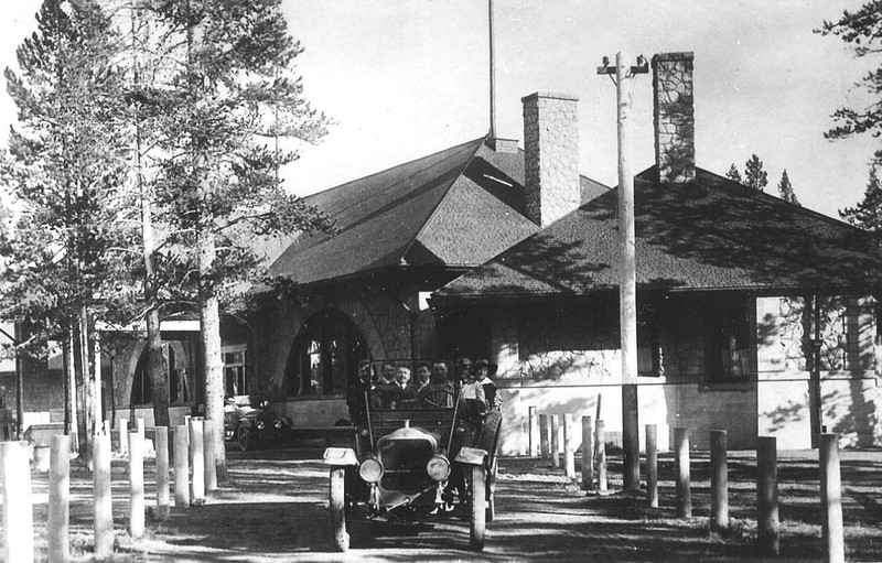 Historic photo of the depot with passengers all loaded up ready to tour Yellowstone National Park. This photo shows the west wing. 