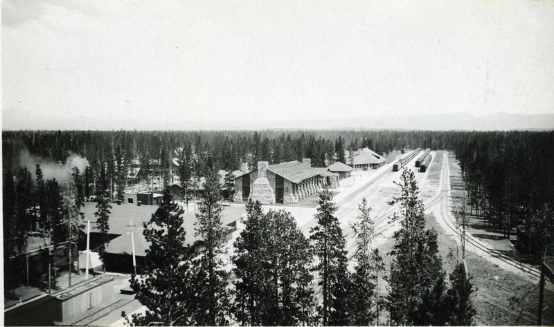 The depot is shown at the top in the row of buildings directly across the tracks from the trains. 