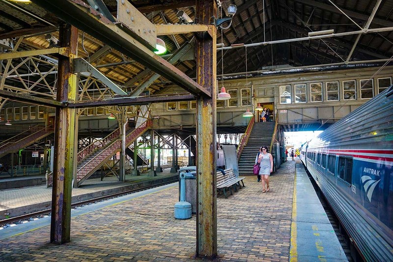 The view from inside the train sheds with the overhead passenger walkway in the background.