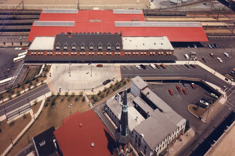 An aerial shot of the HTC with the massive, red-roofed train sheds located behind the station.  