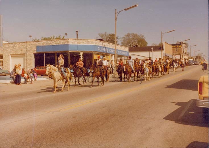 Clifford Chrysler Plymouth, 325 N. Milwaukee Ave., during Bicentennial Wagon Train Parade, 1976